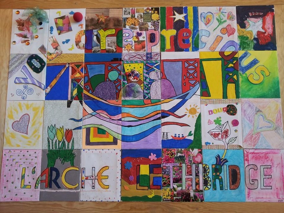 Quilt with "You Are Precious L'Arche Lethbridge" text in the design.